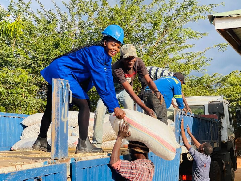 Maness Nkhata, founder of LAPE, with team offloading maize